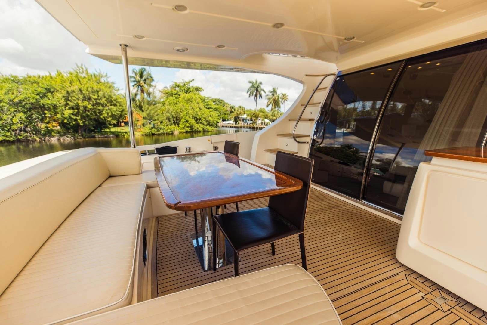 a table and chairs on a deck aboard Azimut 70 Yacht for Sale