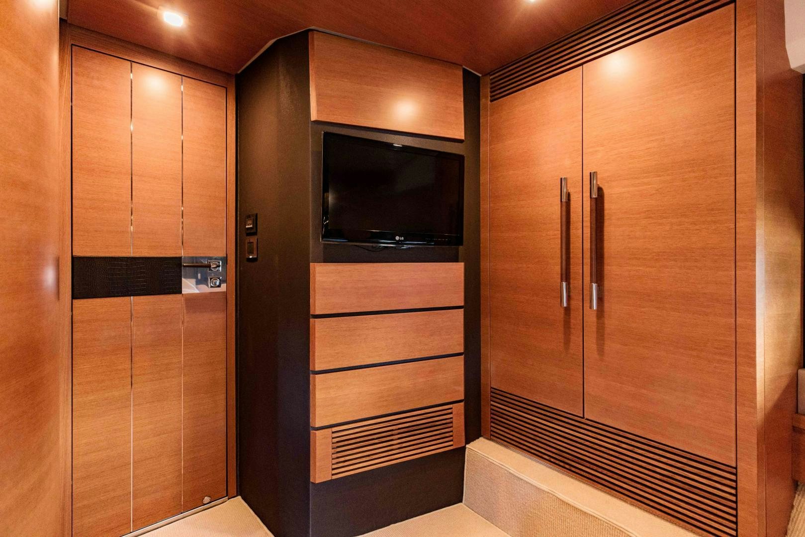 a room with a closet and a microwave aboard Azimut 70 Yacht for Sale