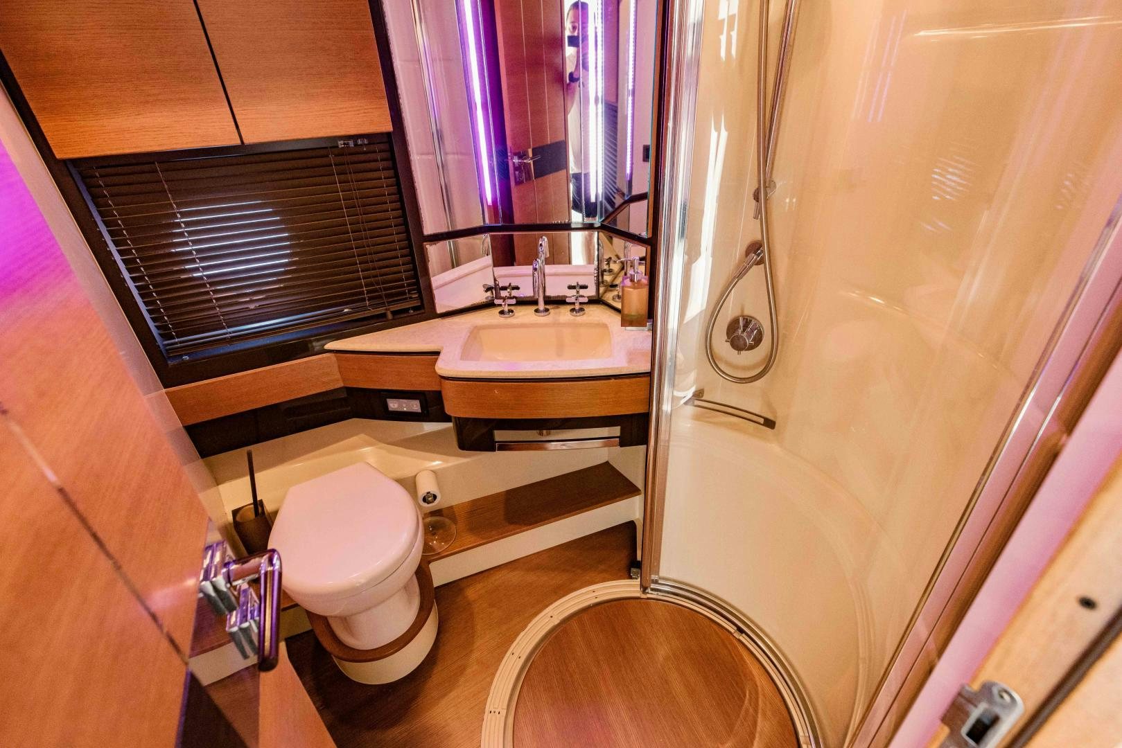 a bathroom with a toilet and sink aboard Azimut 70 Yacht for Sale