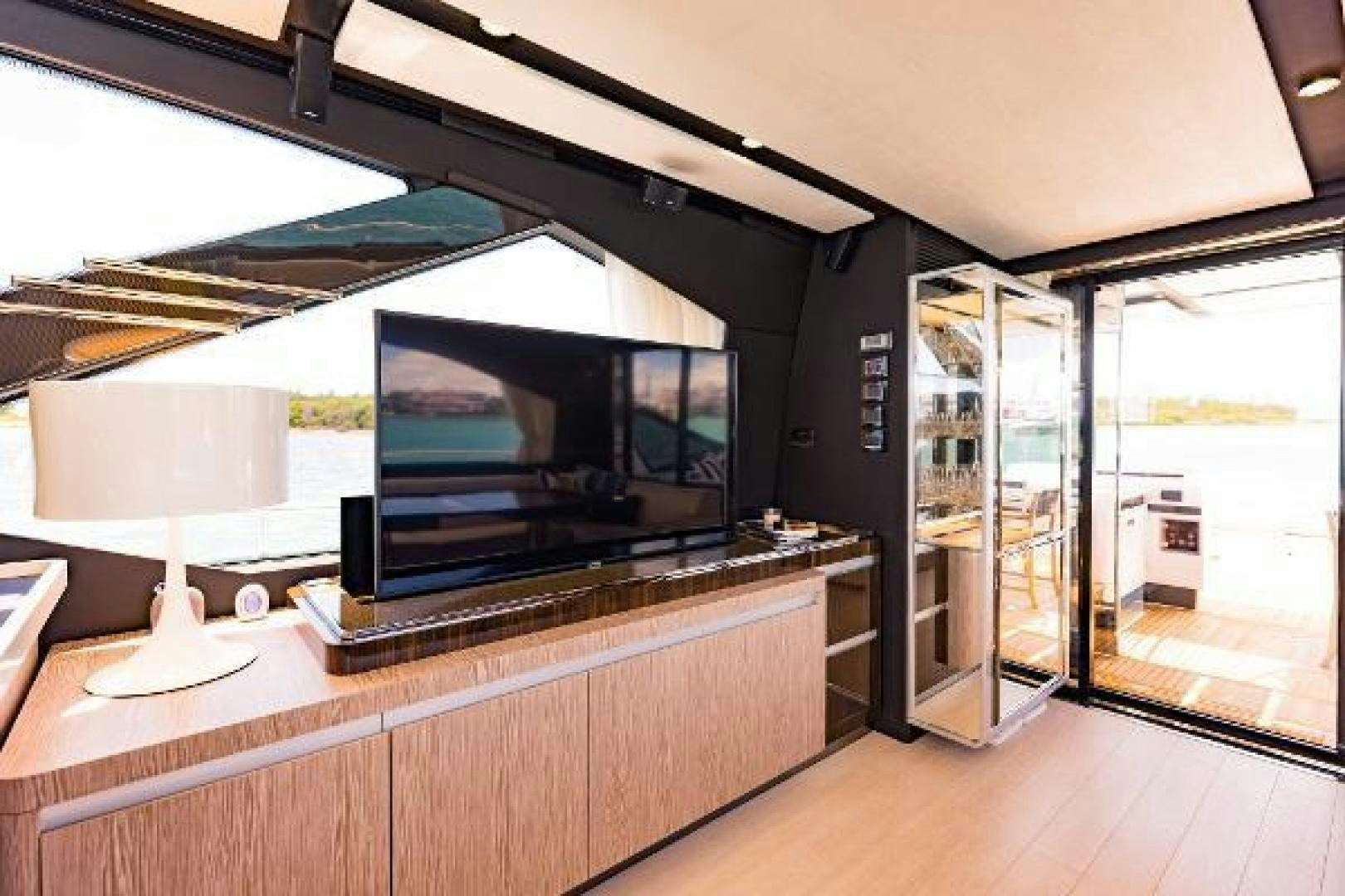a room with a tv and a table aboard SEA BAR Yacht for Sale