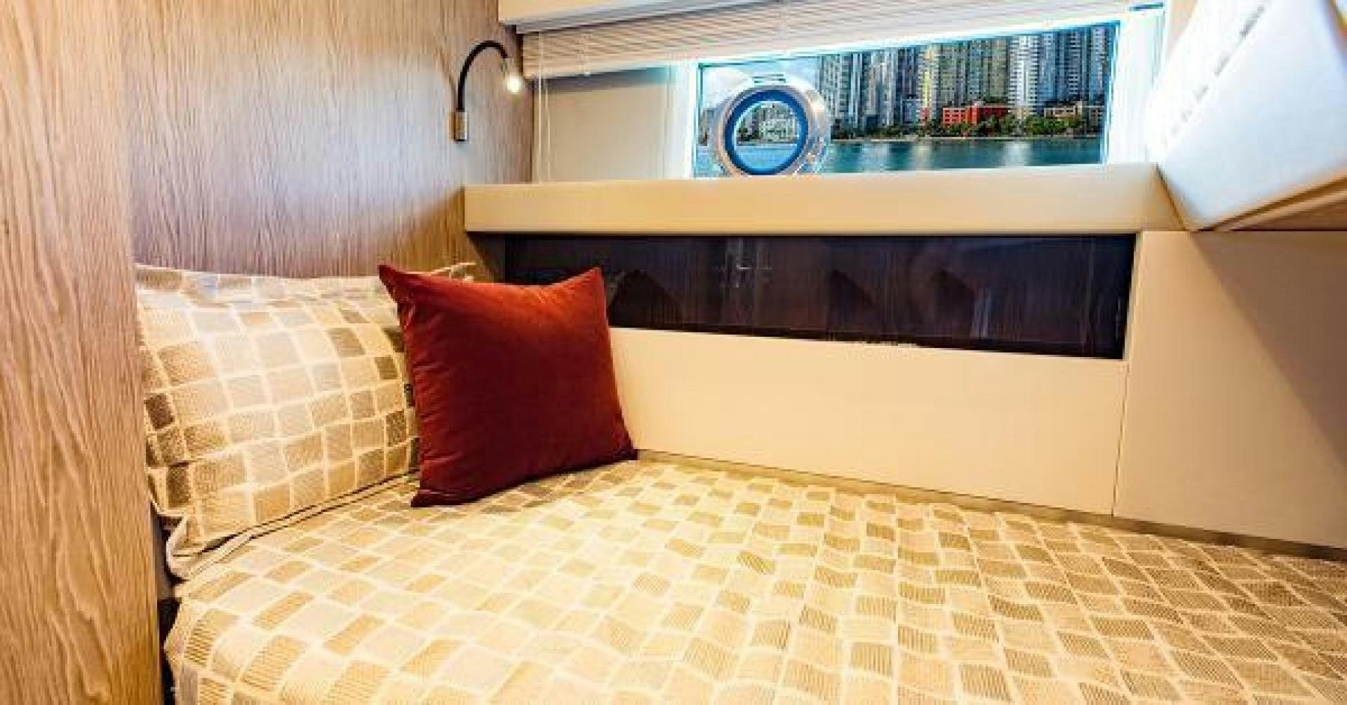 a bed with a pillow and a television on it aboard SEA BAR Yacht for Sale