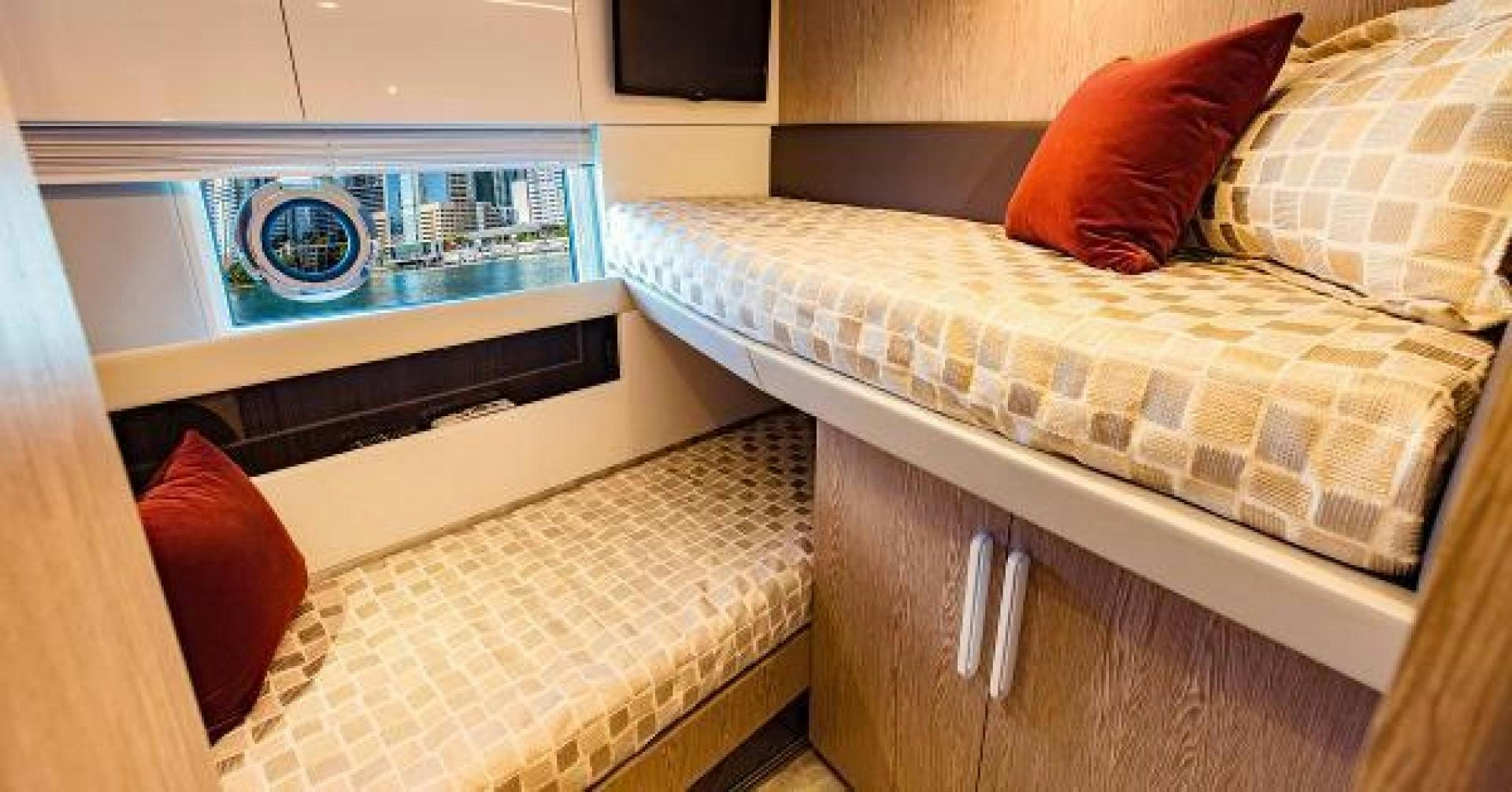 a bed with a bed and a television on it aboard SEA BAR Yacht for Sale