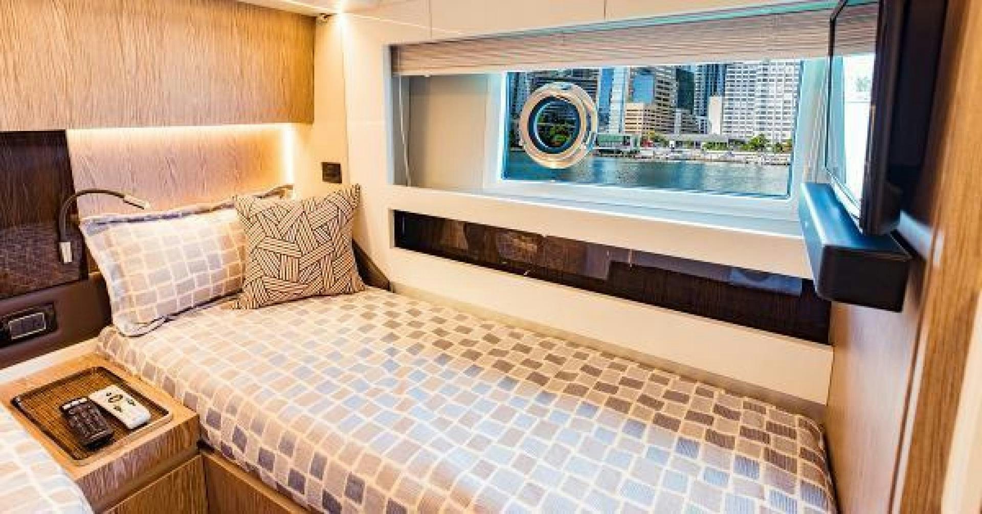 a bed with a window aboard SEA BAR Yacht for Sale