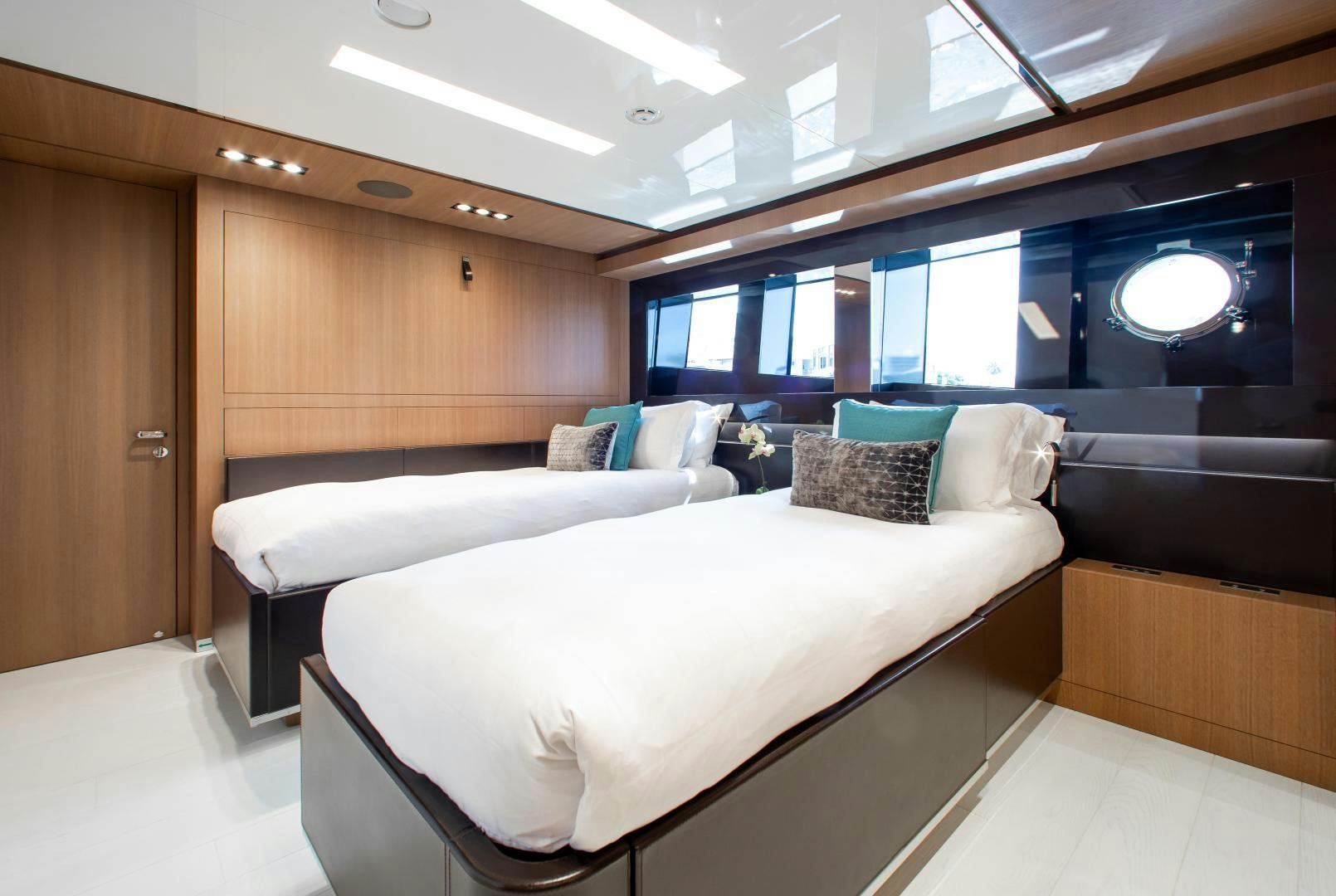 a room with beds and a tv aboard CHOP CHOP Yacht for Sale