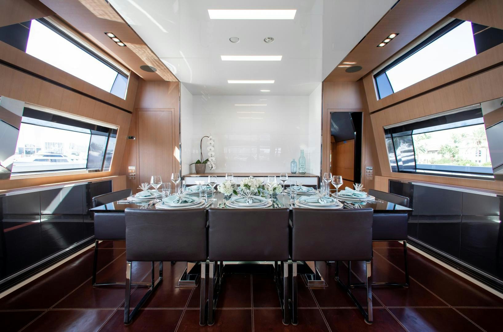 a large room with a table and chairs aboard CHOP CHOP Yacht for Sale