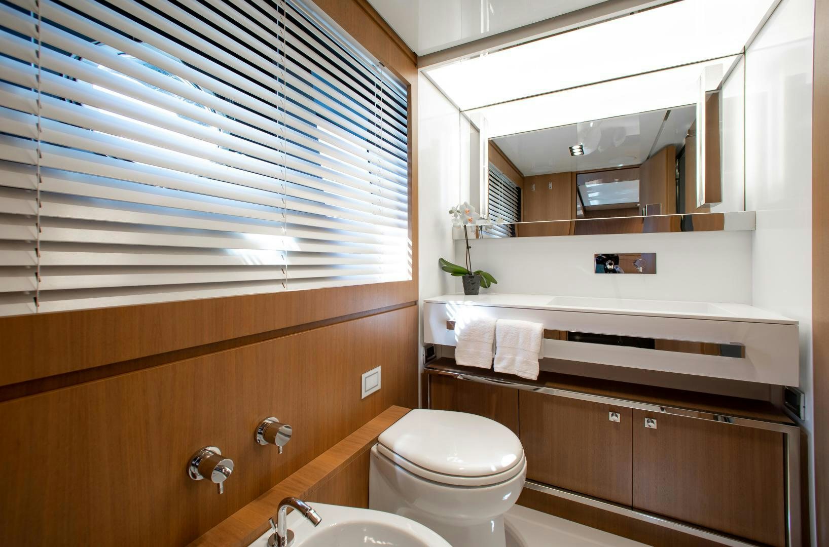 a bathroom with a toilet and a sink aboard CHOP CHOP Yacht for Sale