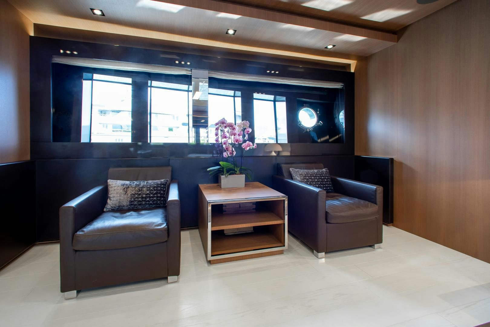 a room with a couch and a coffee table aboard CHOP CHOP Yacht for Sale