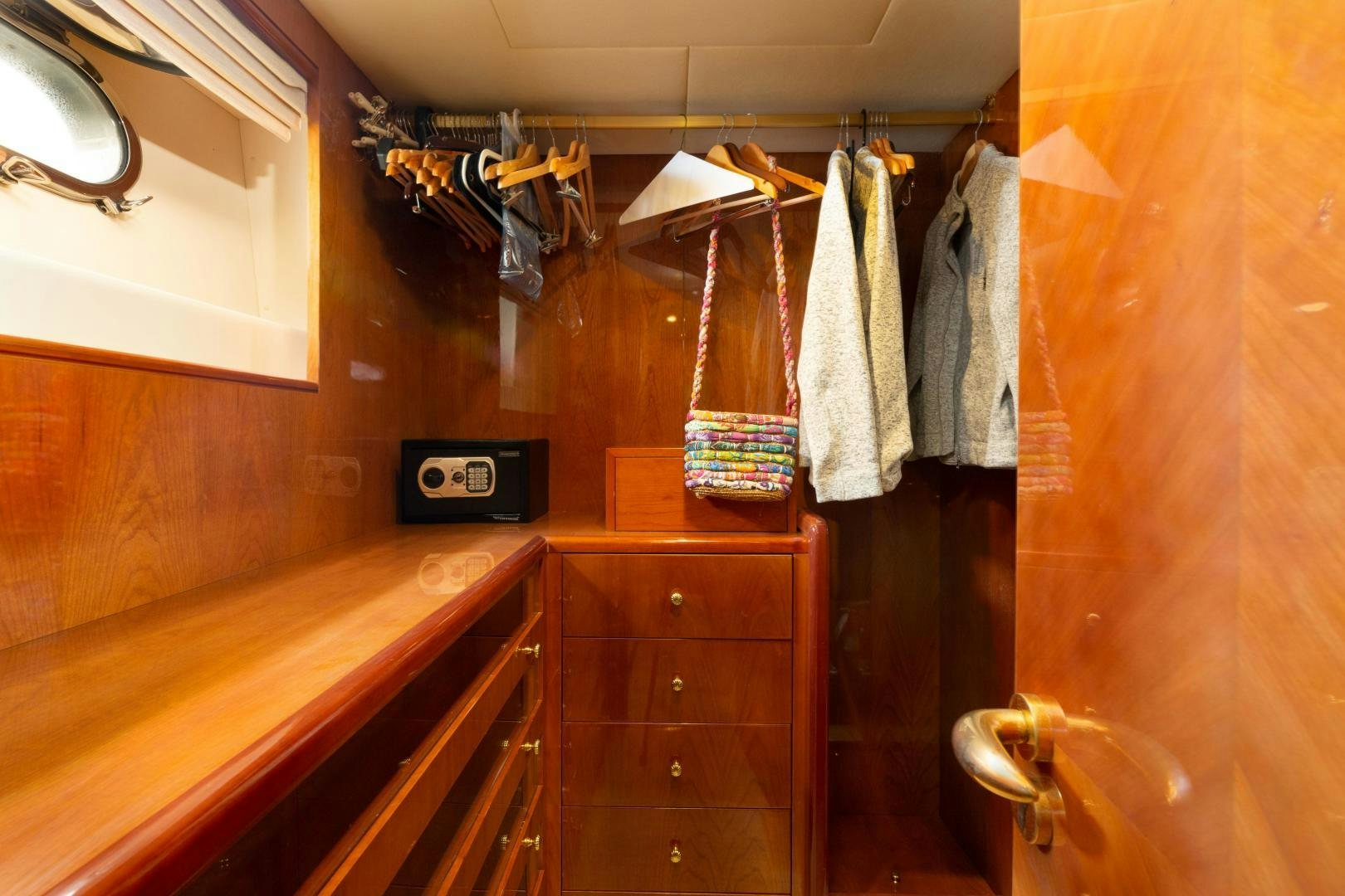 a closet with clothes on the wall aboard GRAVITY Yacht for Sale