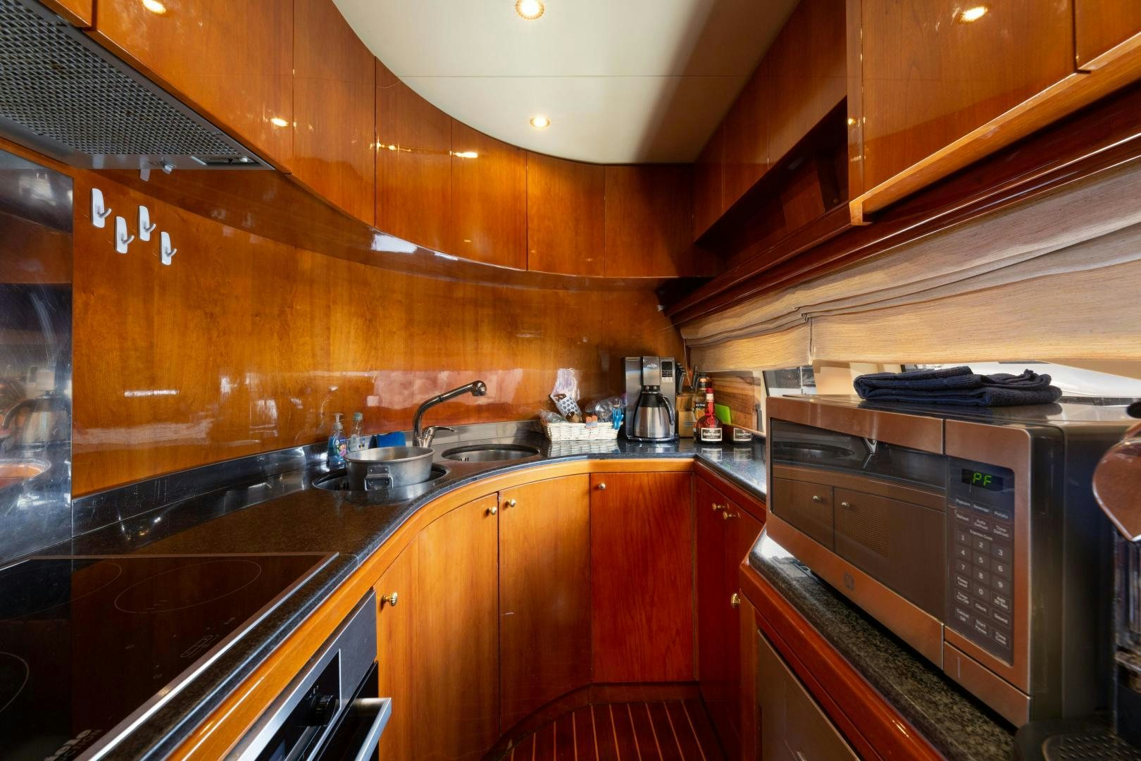 a kitchen with wooden cabinets aboard GRAVITY Yacht for Sale