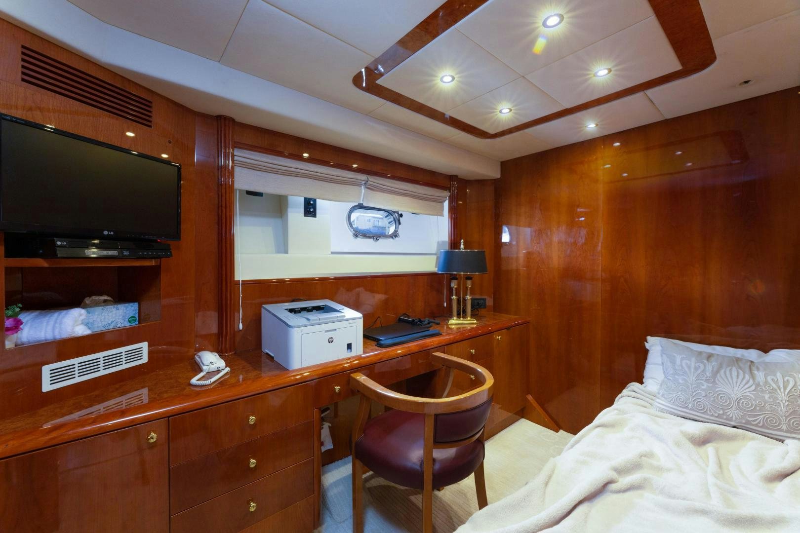 a bedroom with a bed and a television aboard GRAVITY Yacht for Sale