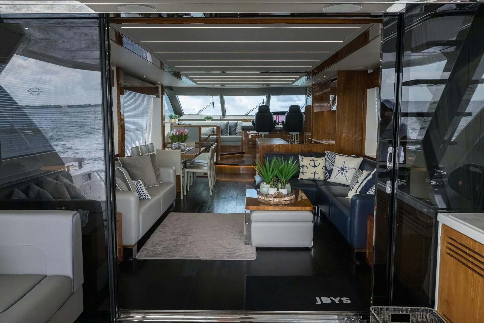 a room with a table and couches aboard MR. G Yacht for Sale