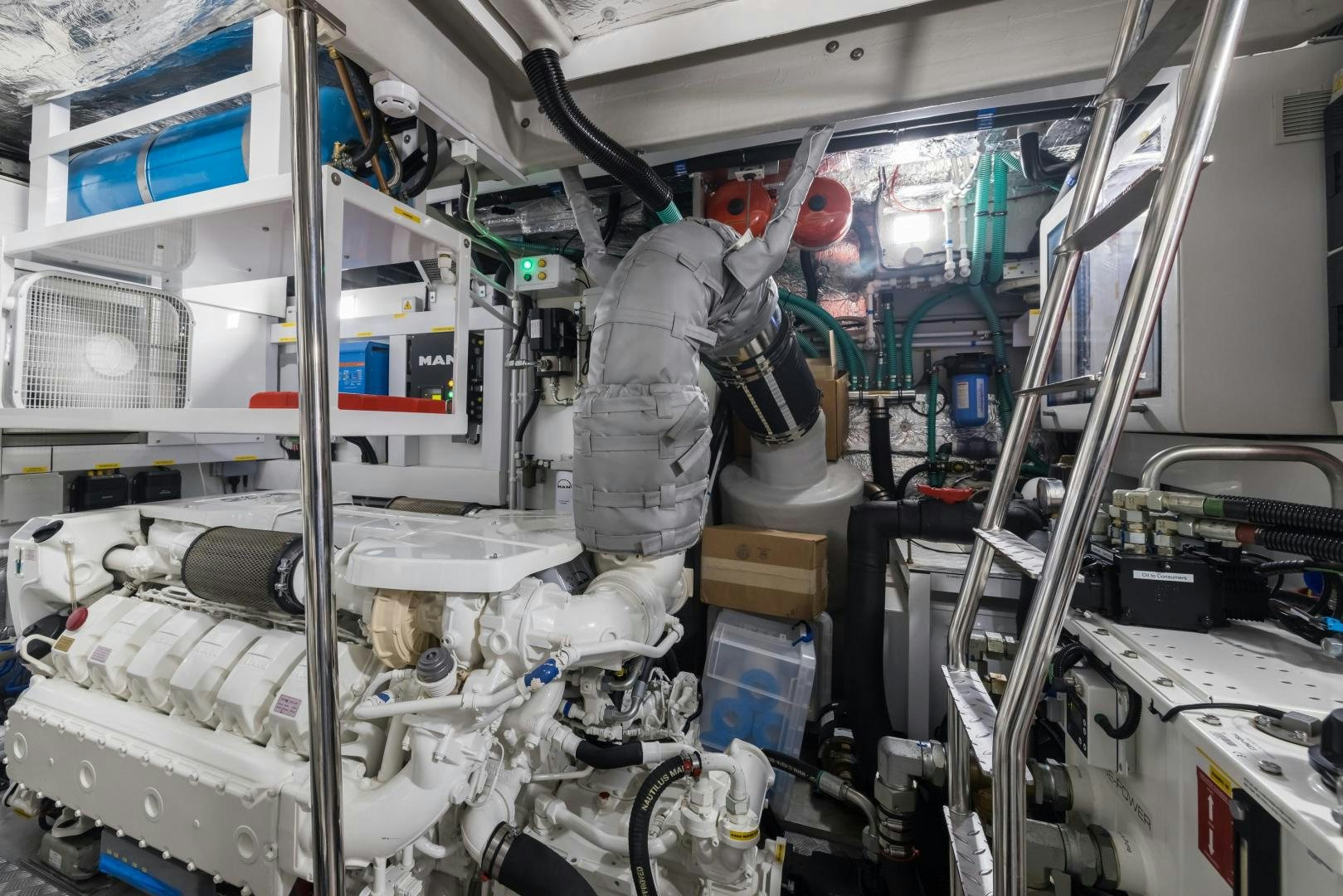 a person in a grey suit in a room with white machines aboard MR. G Yacht for Sale