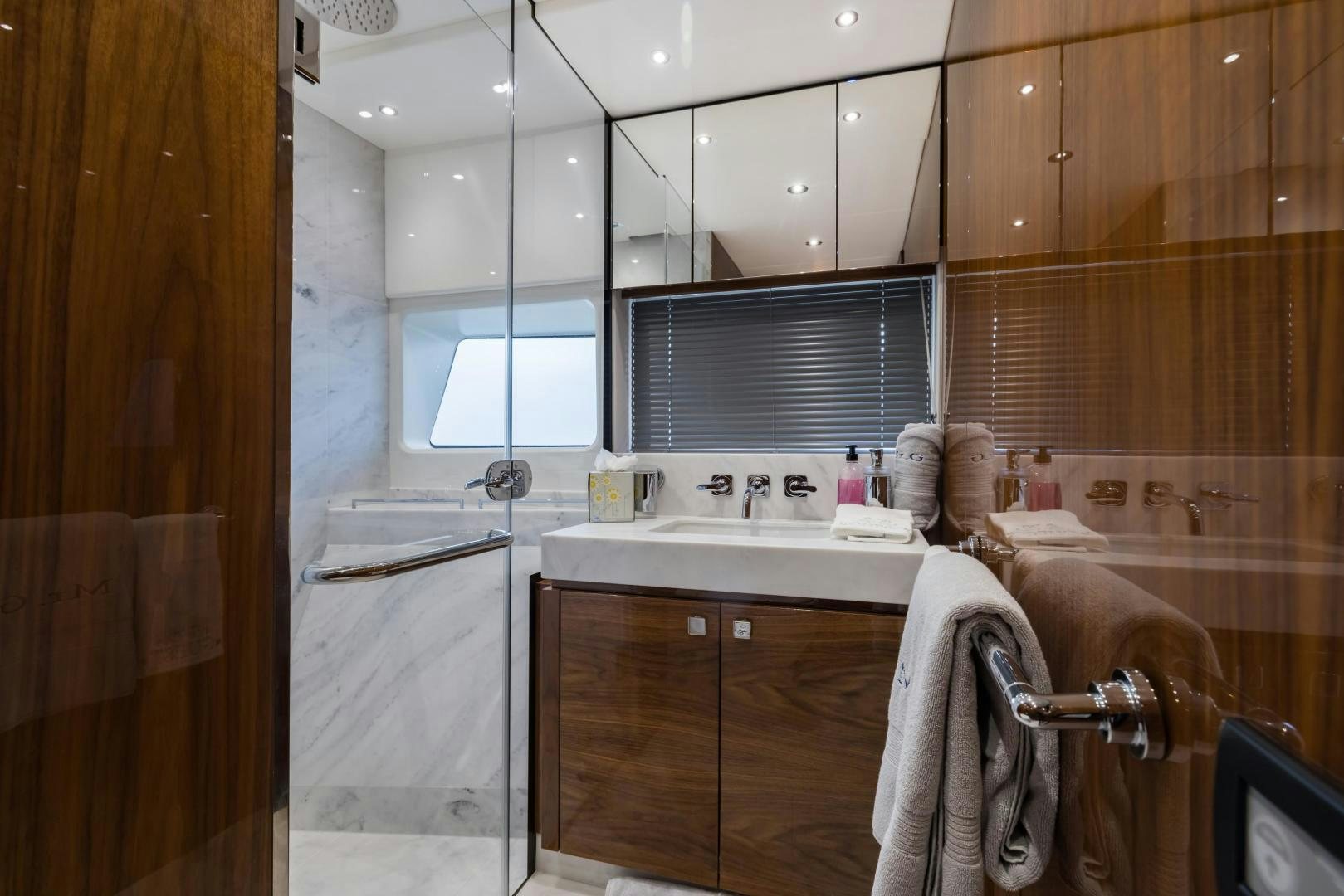 a bathroom with wooden cabinets aboard MR. G Yacht for Sale