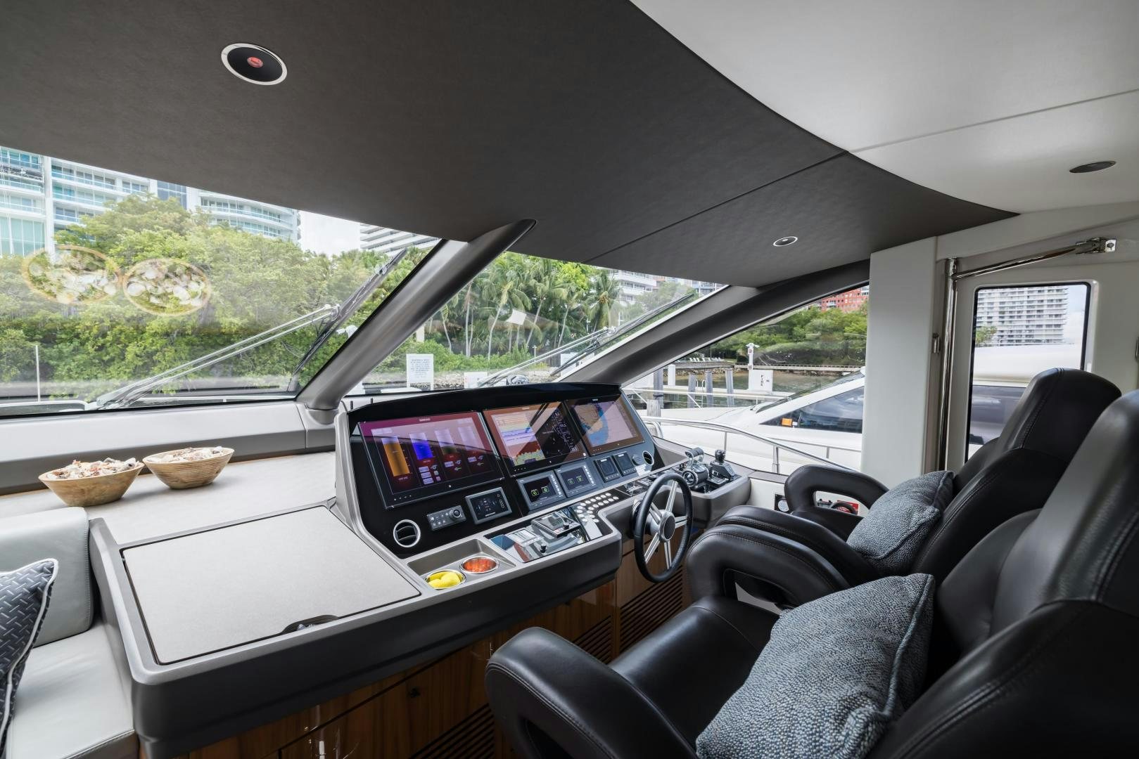 inside of a car with a laptop and a tray of food aboard MR. G Yacht for Sale
