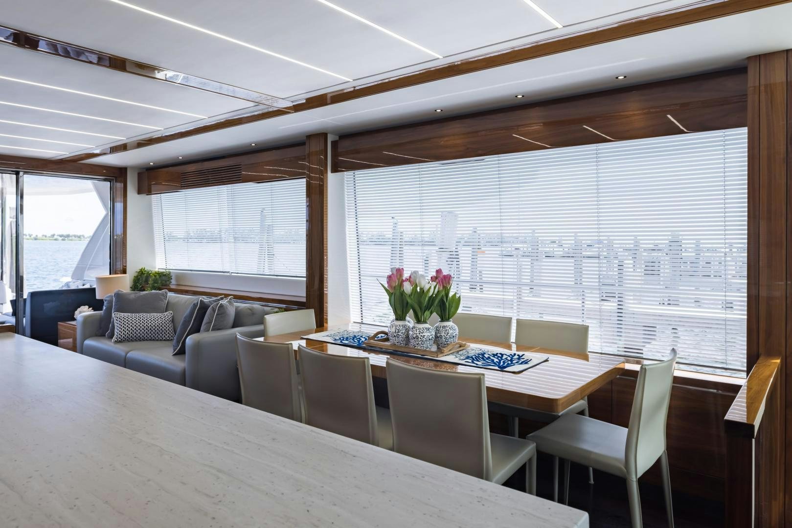 a dining room with a large window aboard MR. G Yacht for Sale