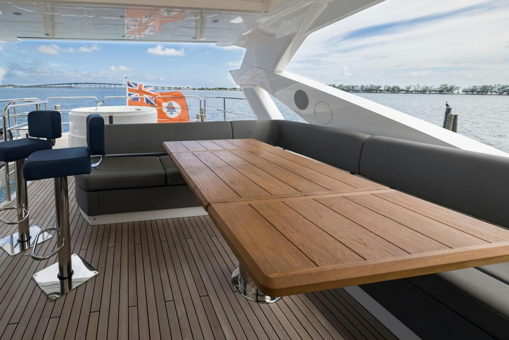 a deck with chairs and a table on it aboard MR. G Yacht for Sale