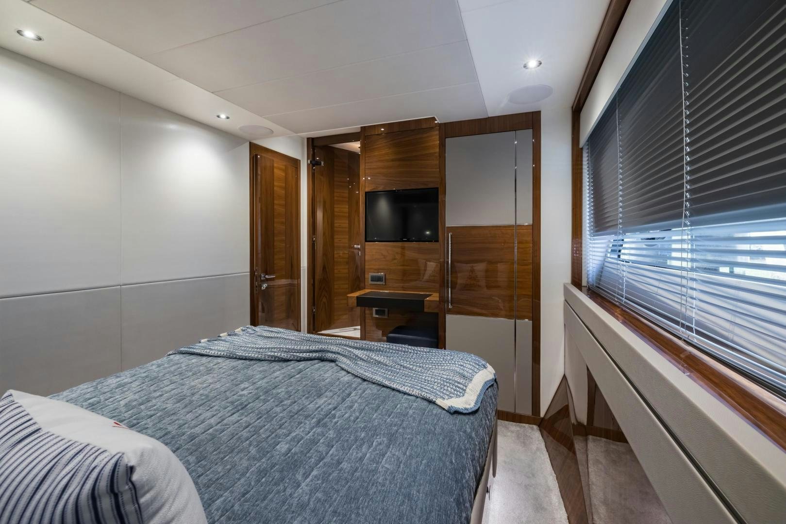 a bedroom with a bed and a television aboard MR. G Yacht for Sale