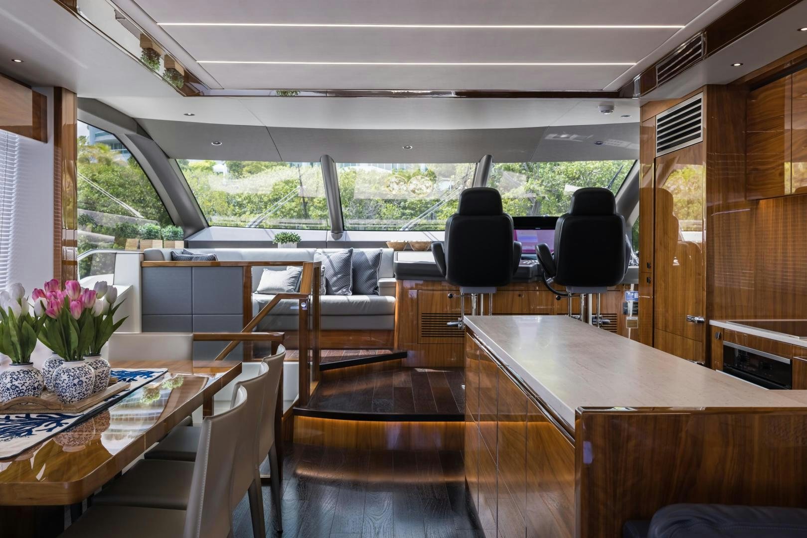 a room with tables and chairs aboard MR. G Yacht for Sale