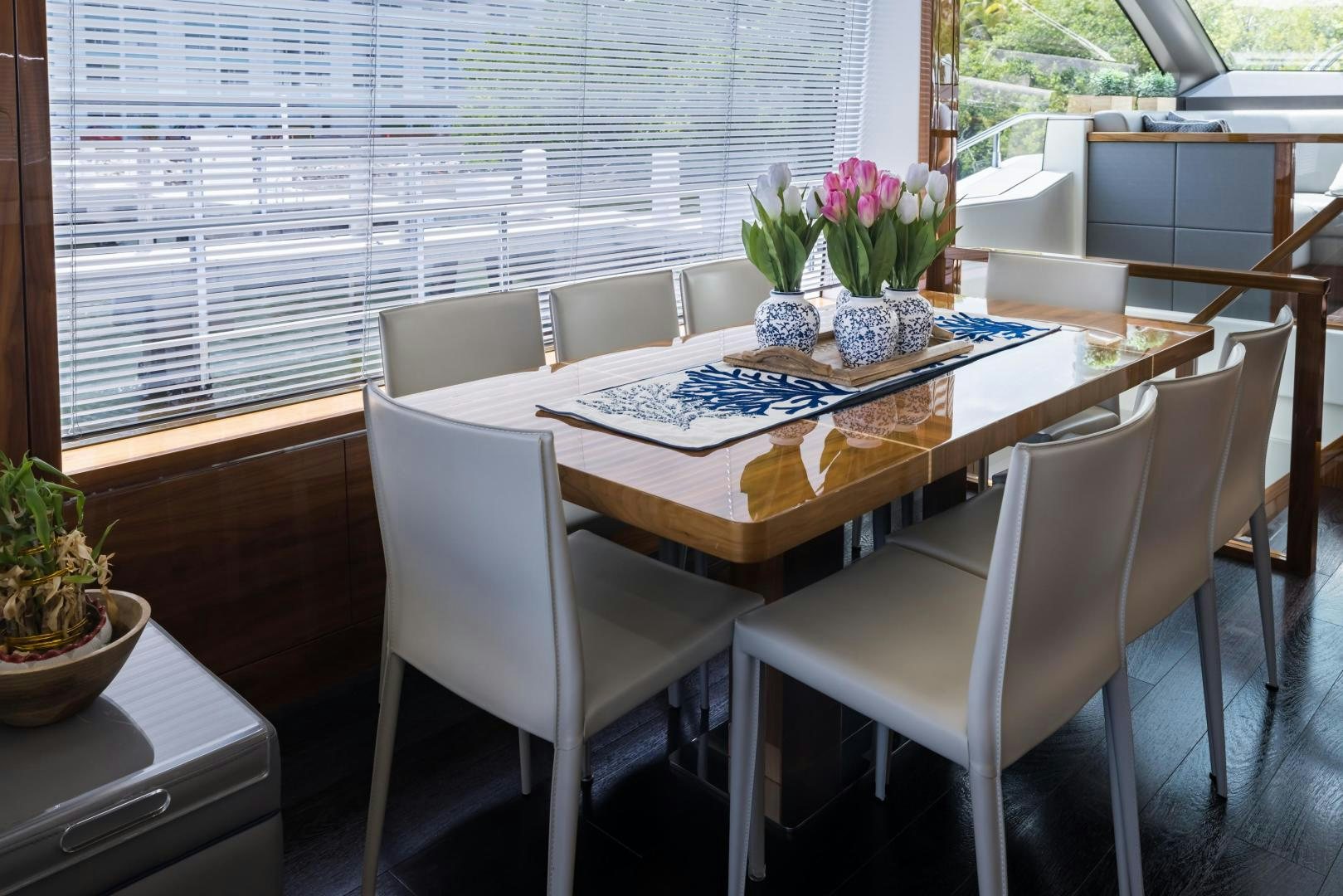 a table with chairs and a plant on it aboard MR. G Yacht for Sale