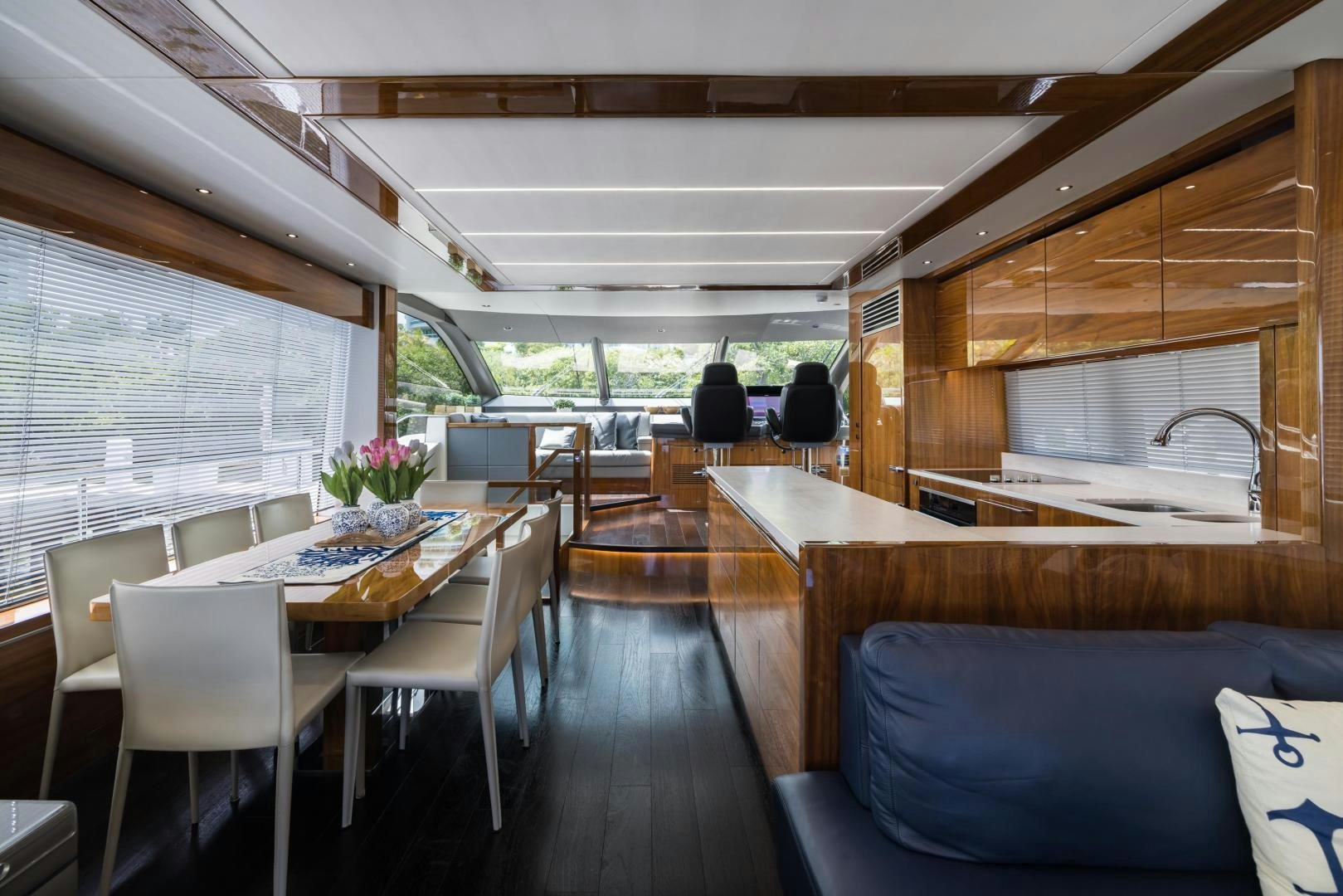 a large wood table in a room aboard MR. G Yacht for Sale