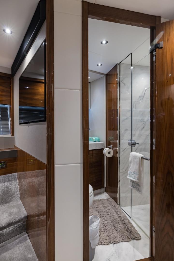 a bathroom with a glass shower aboard MR. G Yacht for Sale