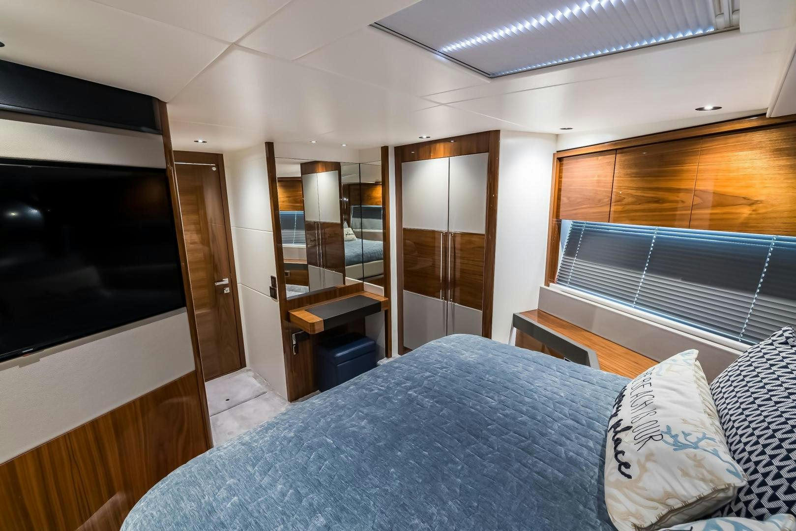 a bedroom with a bed and a desk aboard MR. G Yacht for Sale