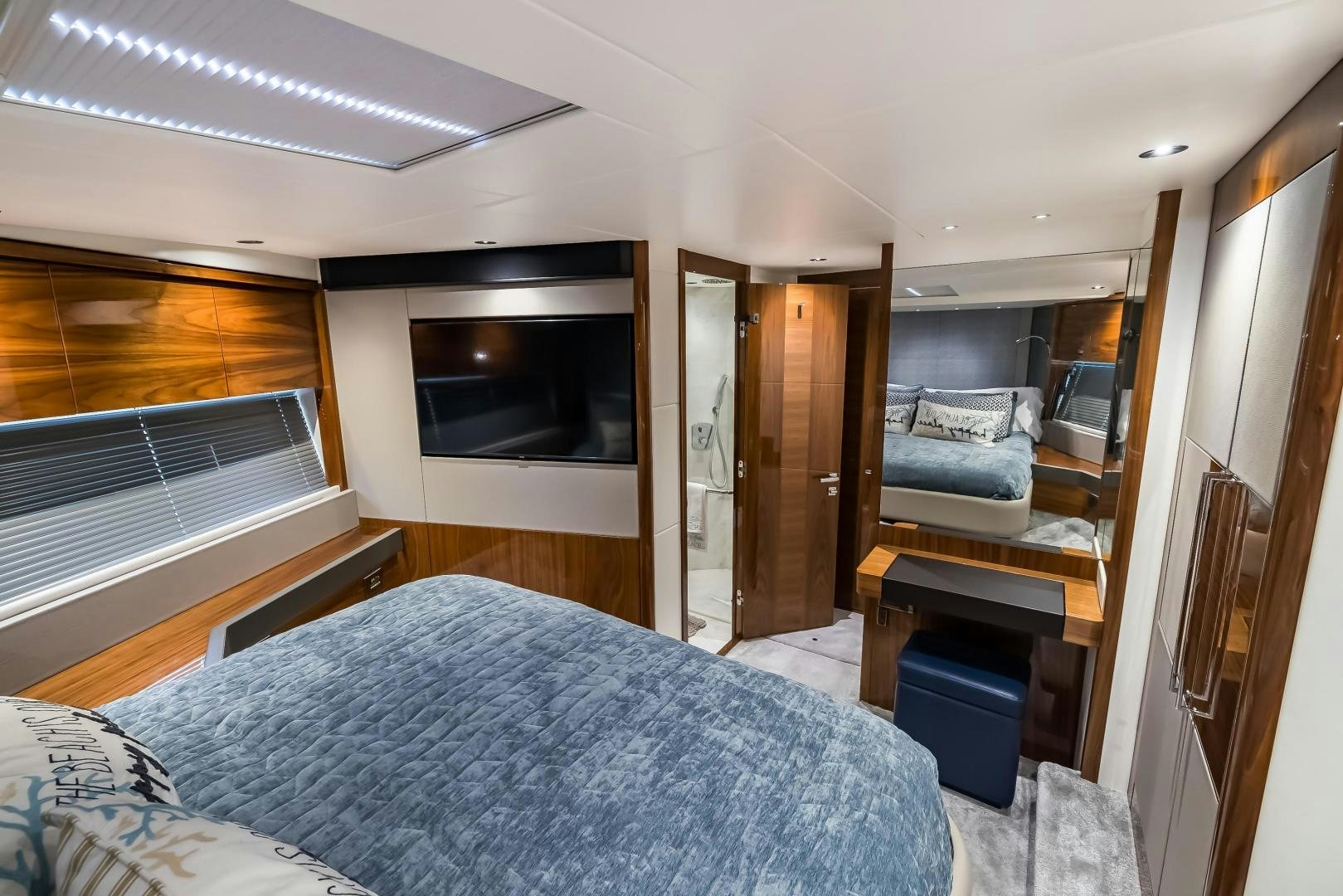 a bedroom with a bed and a television aboard MR. G Yacht for Sale