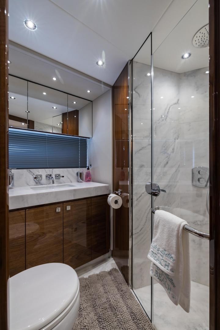 a bathroom with a glass shower aboard MR. G Yacht for Sale