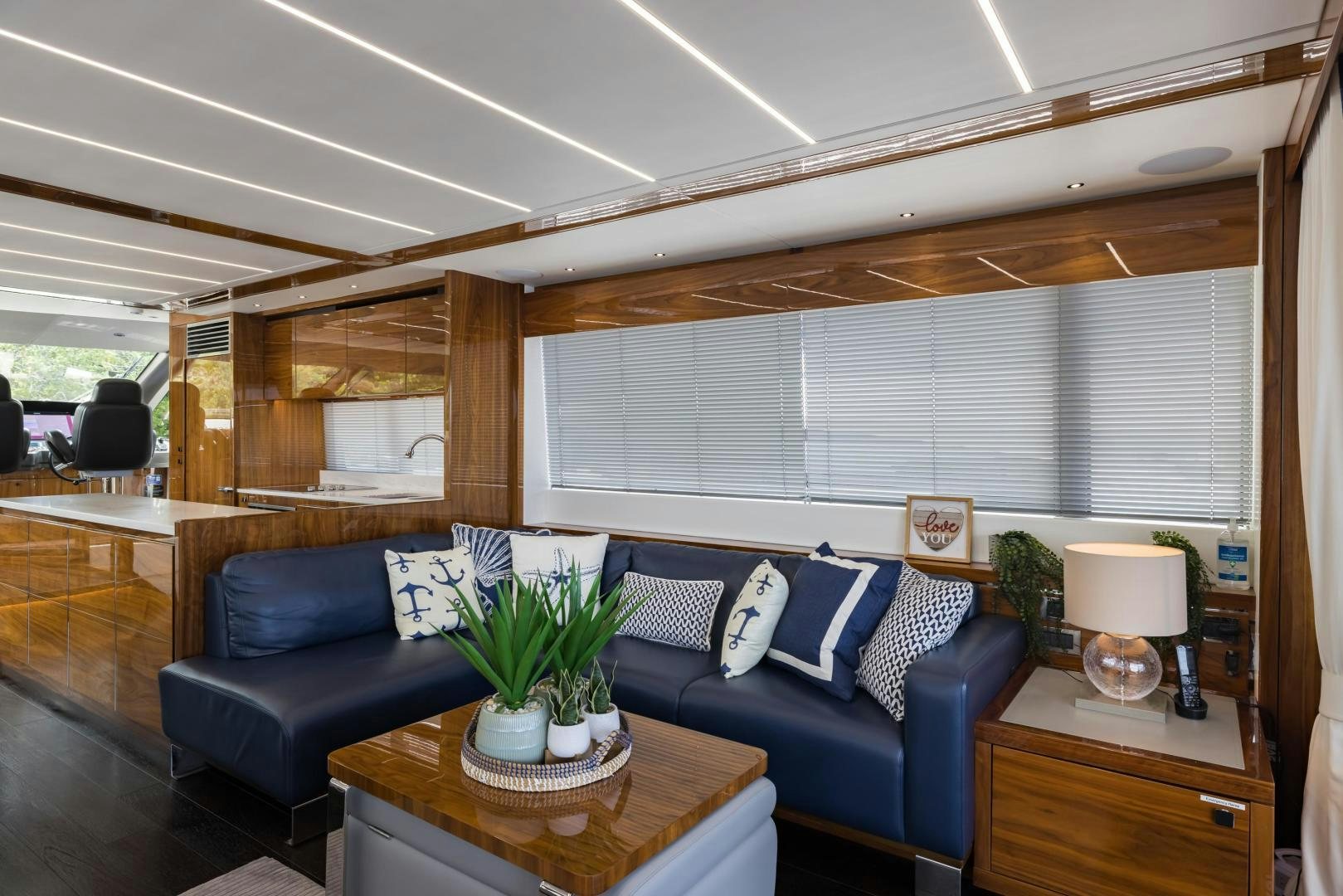 a living room with a blue couch aboard MR. G Yacht for Sale