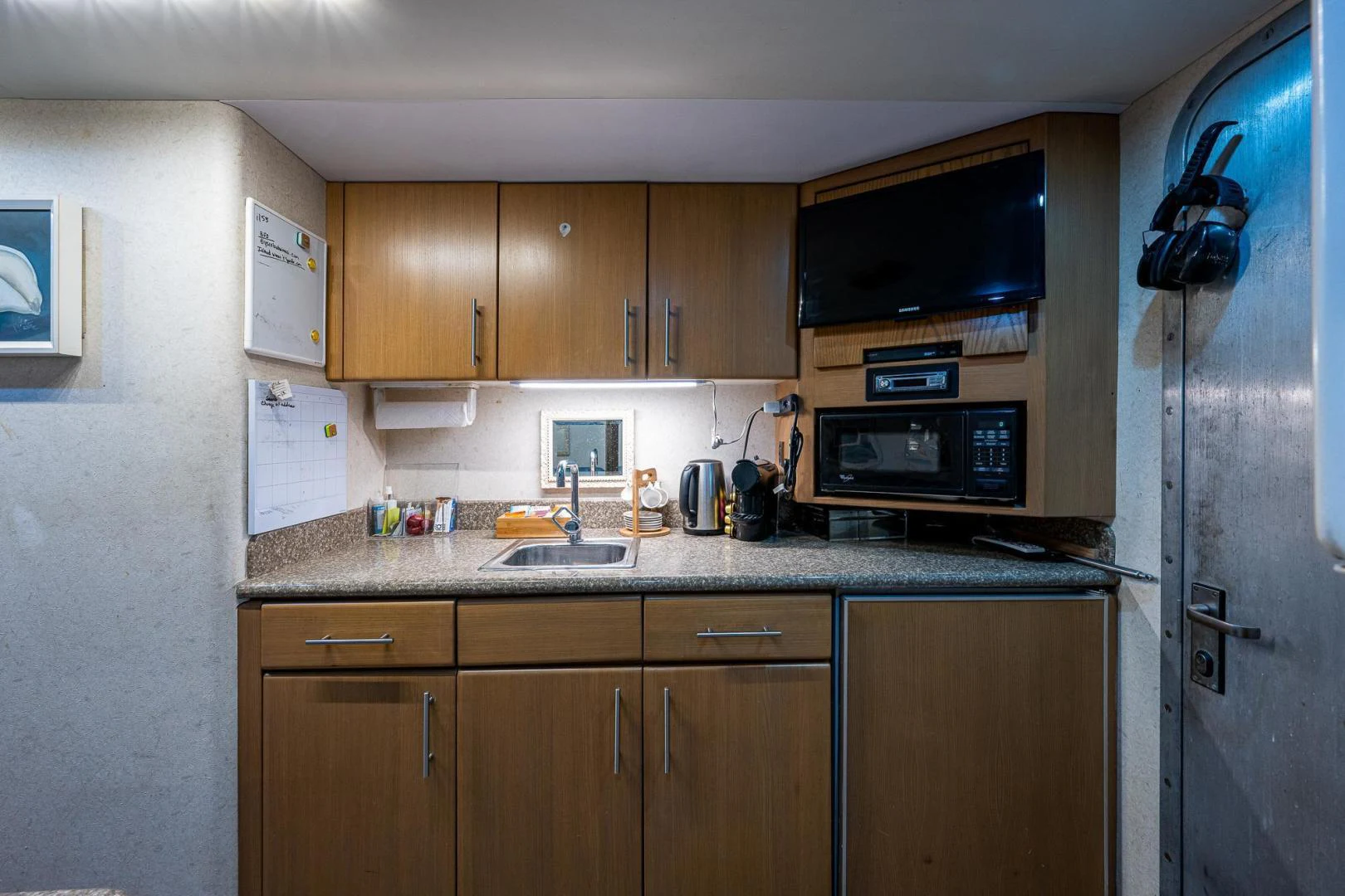 a kitchen with wooden cabinets aboard ATLANTIC Yacht for Sale