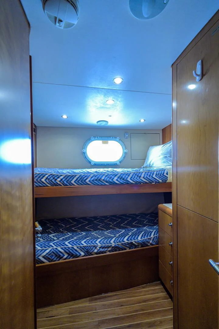 a room with a bed and a window aboard IRISH EI'S Yacht for Sale