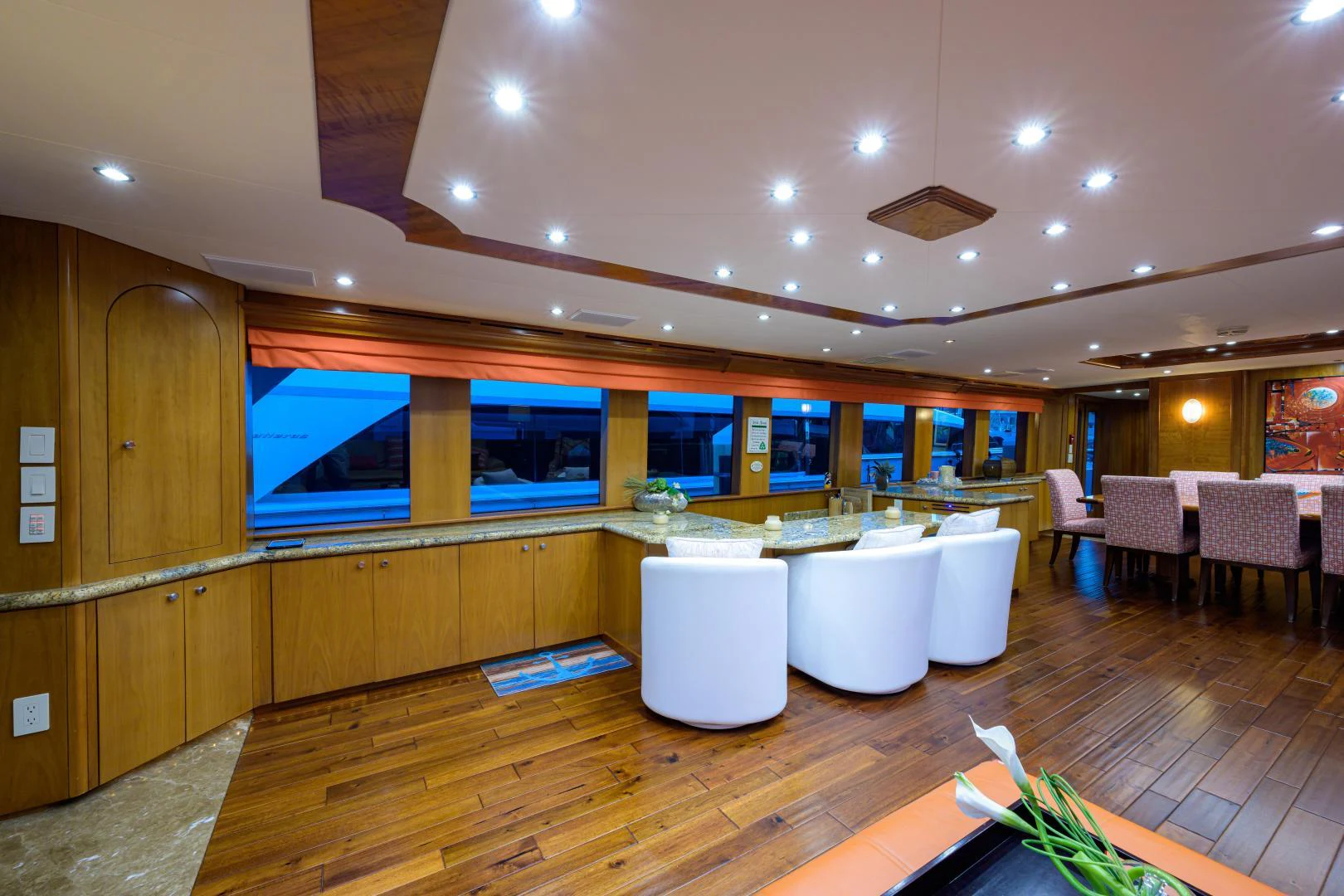 a room with tables and chairs aboard IRISH EI'S Yacht for Sale