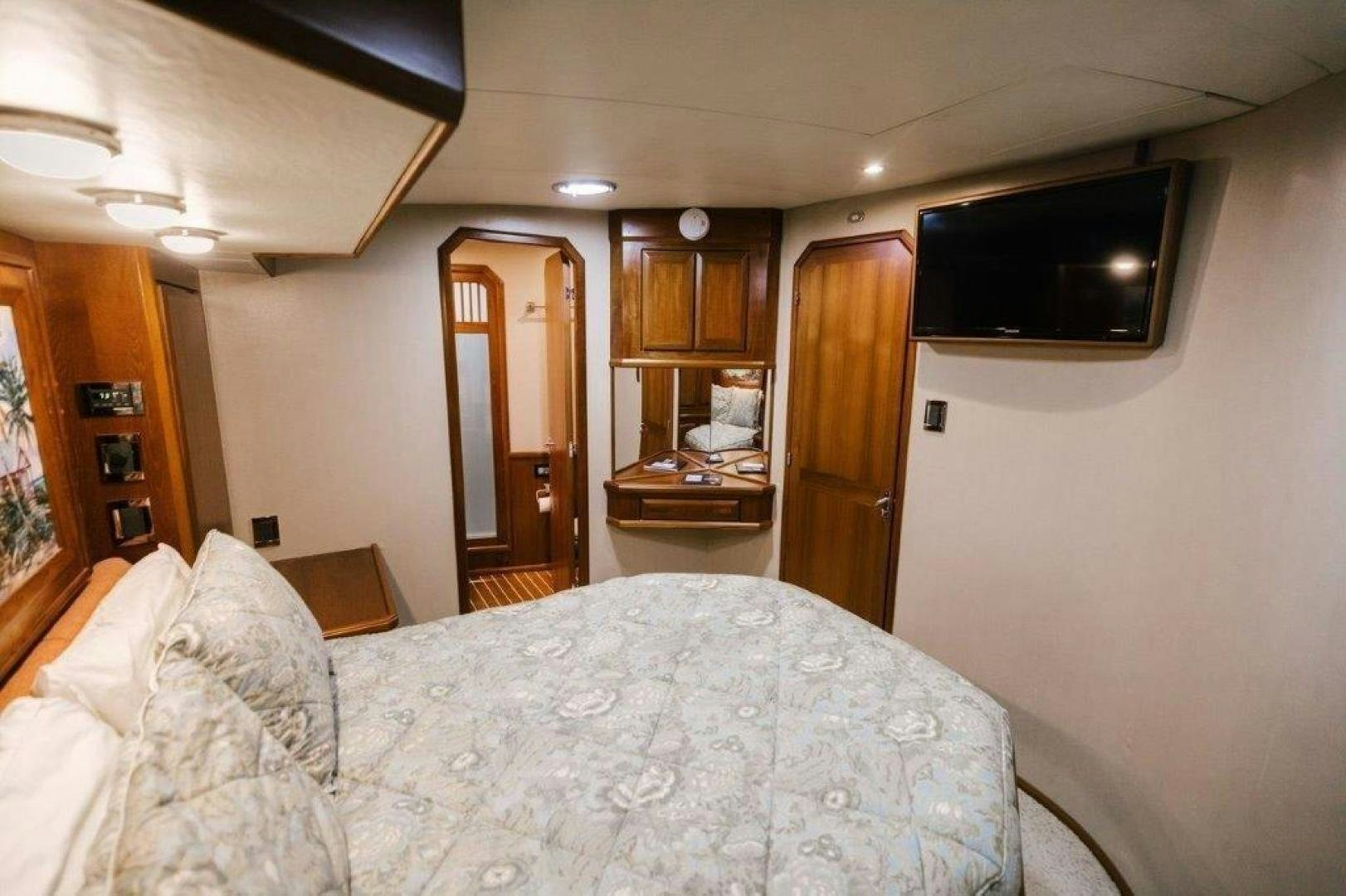 a bedroom with a bed and a television aboard PULLIN WIRE Yacht for Sale