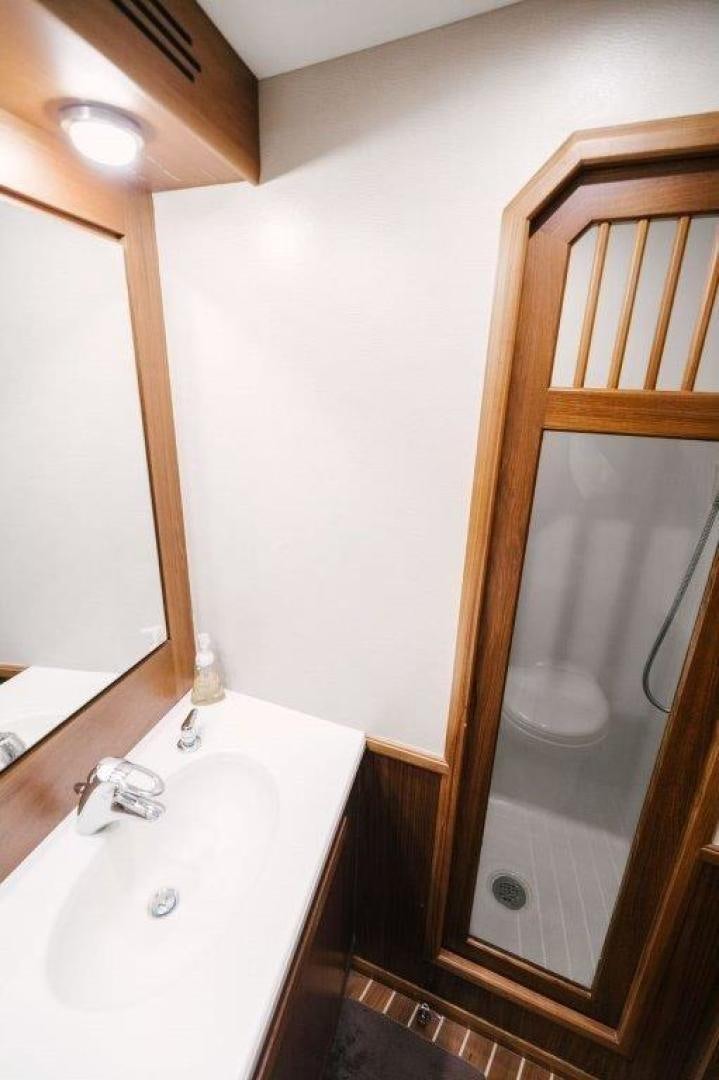 a bathroom with a mirror aboard PULLIN WIRE Yacht for Sale