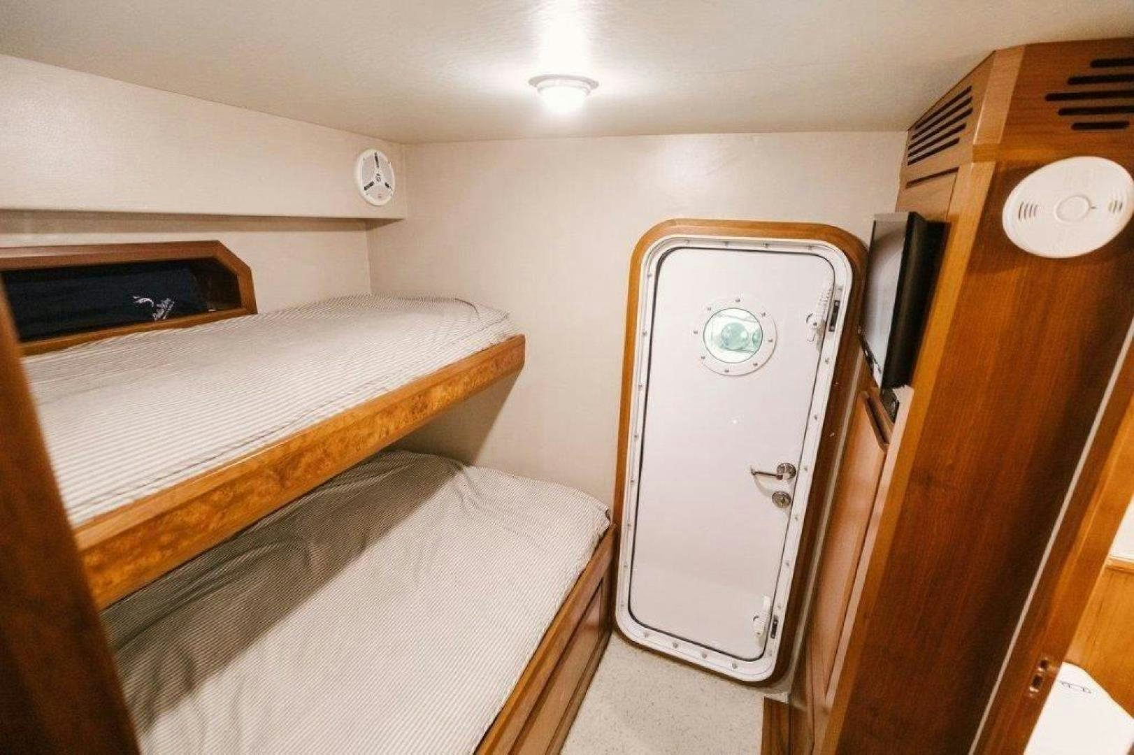 a room with a bed and a closet aboard PULLIN WIRE Yacht for Sale