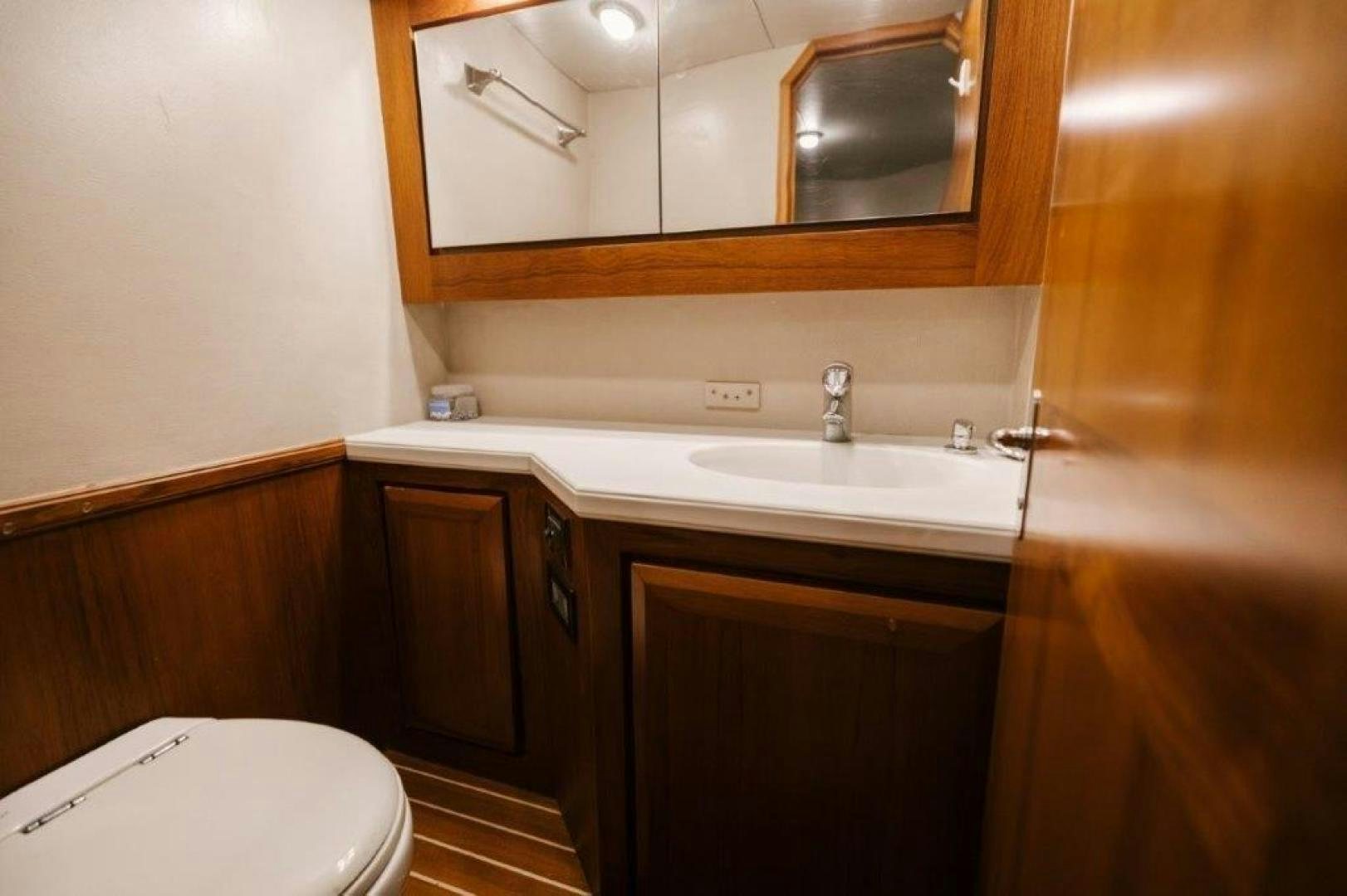 a bathroom with a sink and a toilet aboard PULLIN WIRE Yacht for Sale