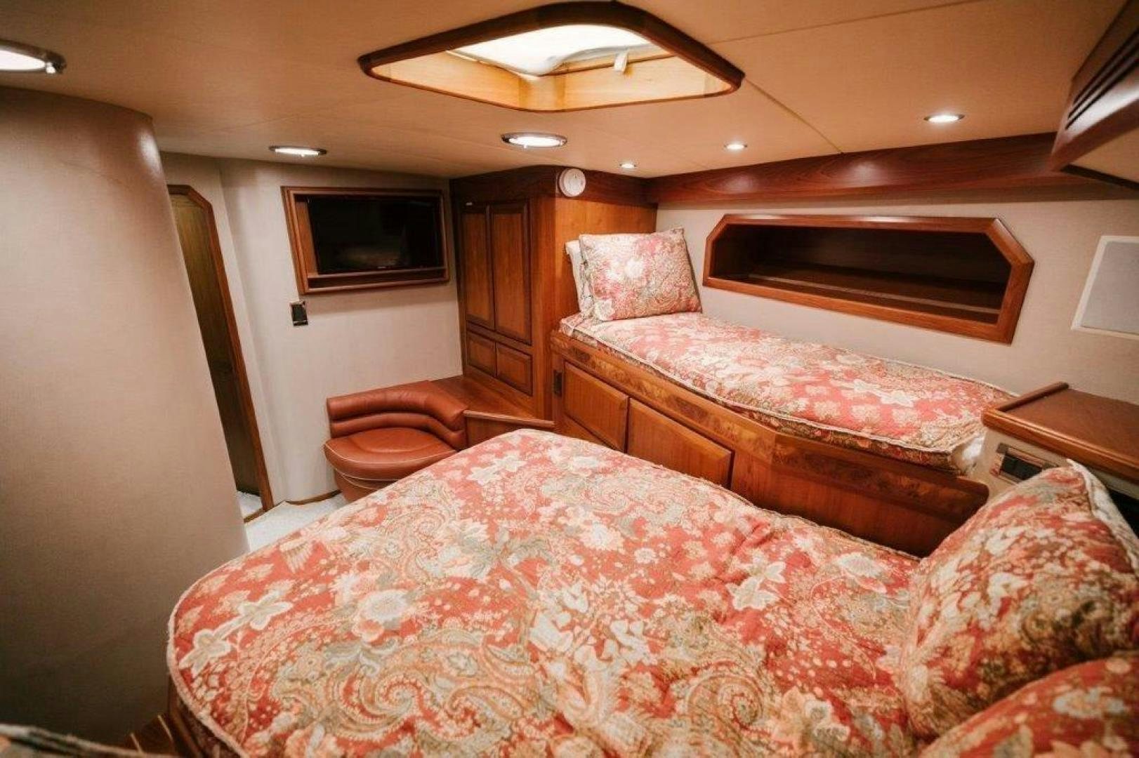 a bedroom with a bed and a television aboard PULLIN WIRE Yacht for Sale