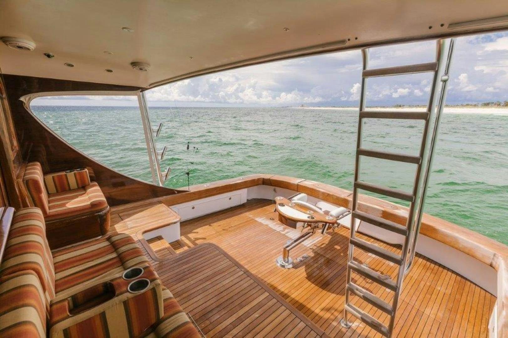 a deck with a view of the ocean and mountains aboard PULLIN WIRE Yacht for Sale
