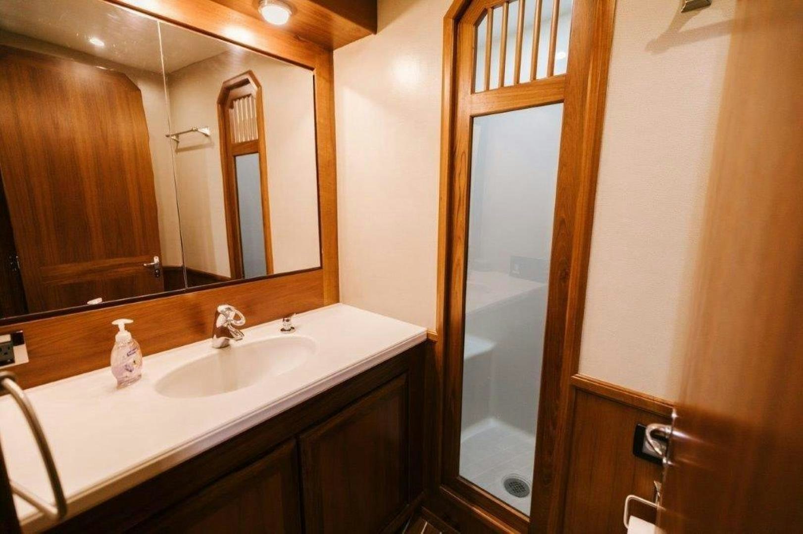 a bathroom with a sink and a mirror aboard PULLIN WIRE Yacht for Sale