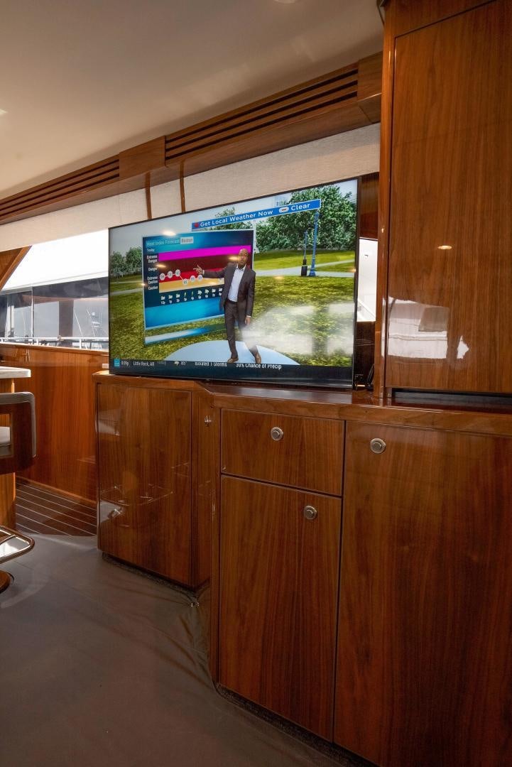 a tv on a stand in a room aboard DAWG DAZE Yacht for Sale