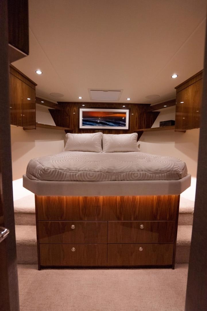 a bed with a television on the wall aboard DAWG DAZE Yacht for Sale