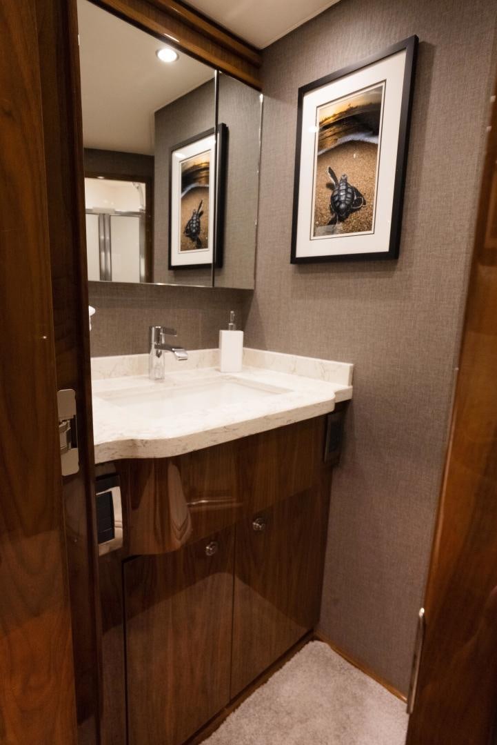 a bathroom with a sink and a mirror aboard DAWG DAZE Yacht for Sale