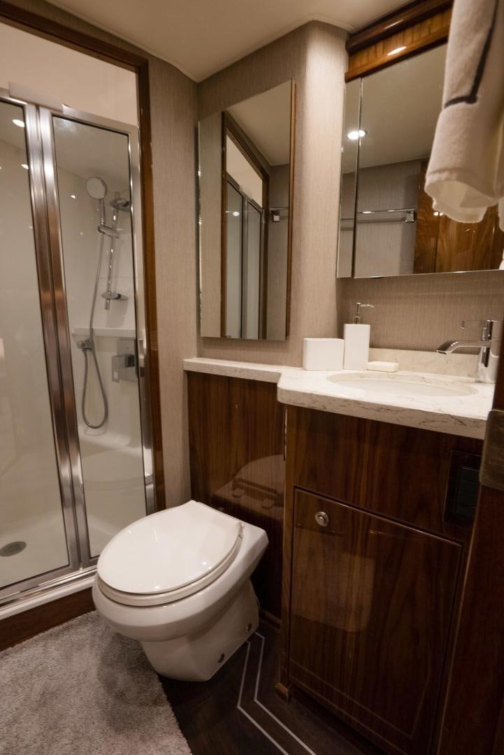a bathroom with a glass shower aboard DAWG DAZE Yacht for Sale