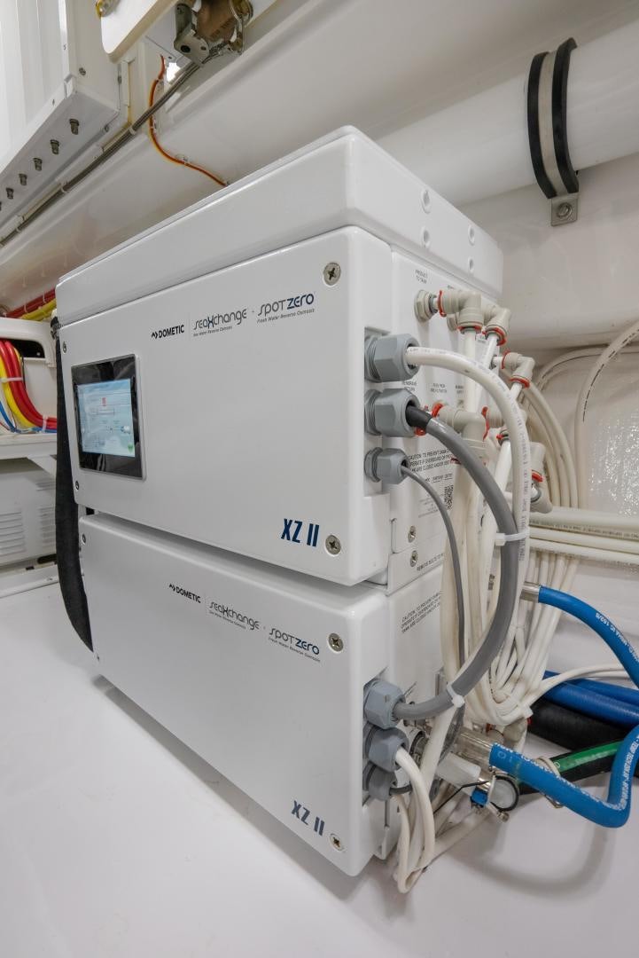 a white machine with a blue cable aboard DAWG DAZE Yacht for Sale