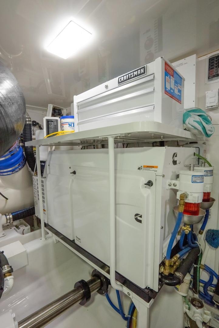 a large white machine with a blue cap and a blue tube aboard DAWG DAZE Yacht for Sale