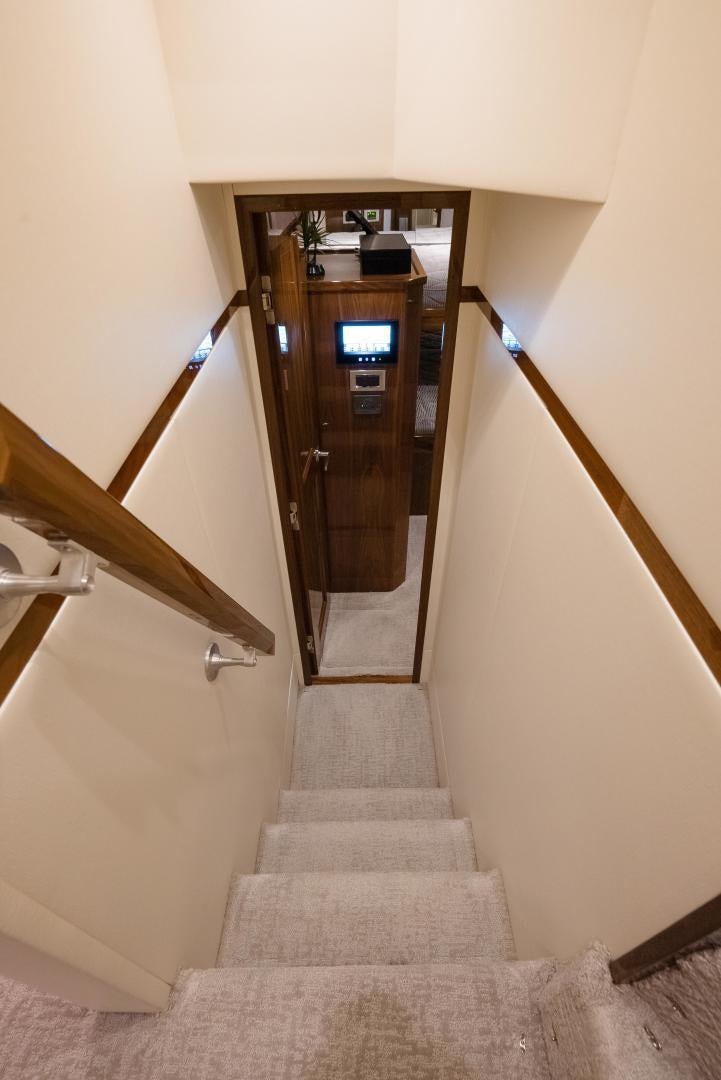 a staircase with a door and a carpet aboard DAWG DAZE Yacht for Sale