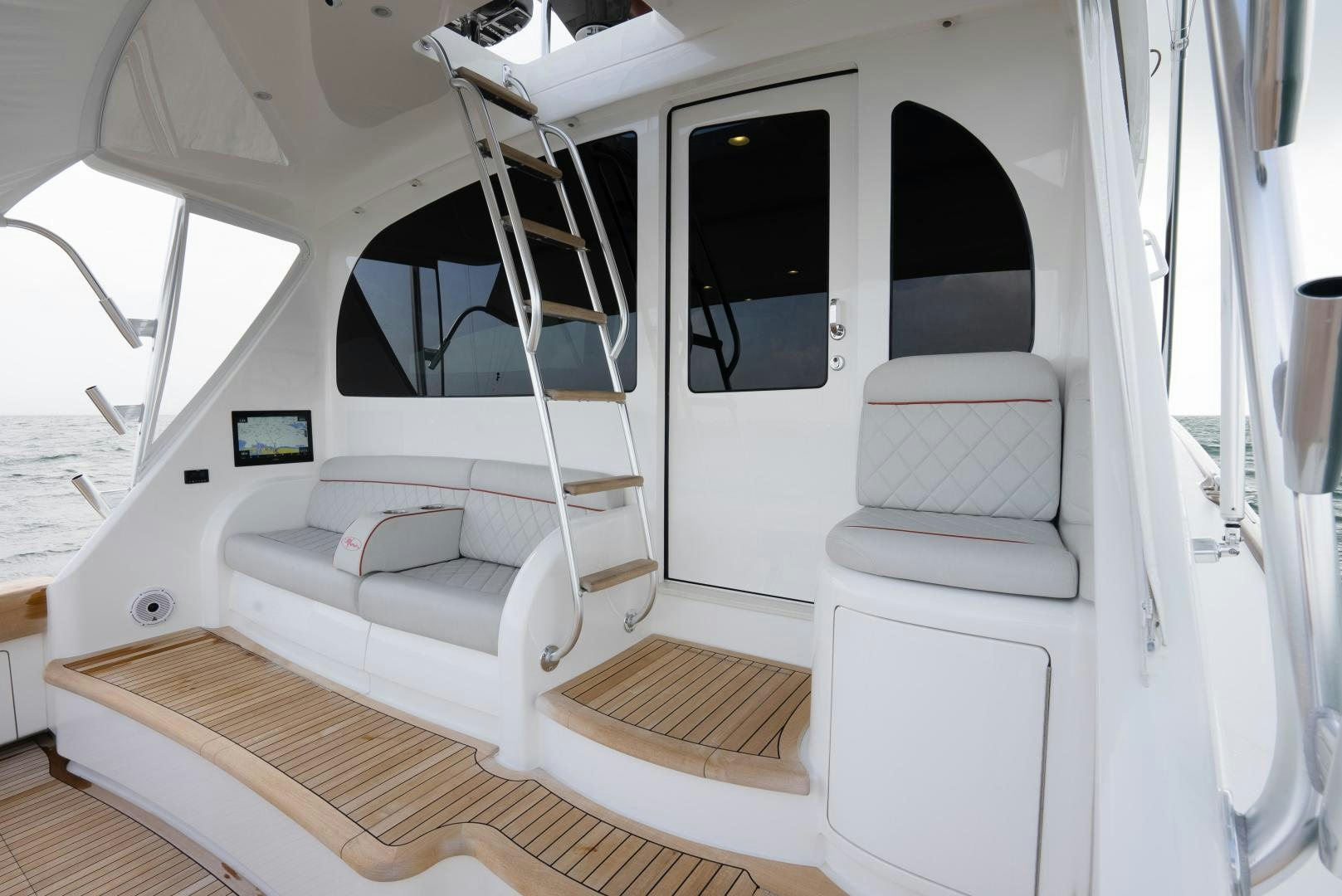 a white boat with a white bed frame and a white couch aboard DAWG DAZE Yacht for Sale