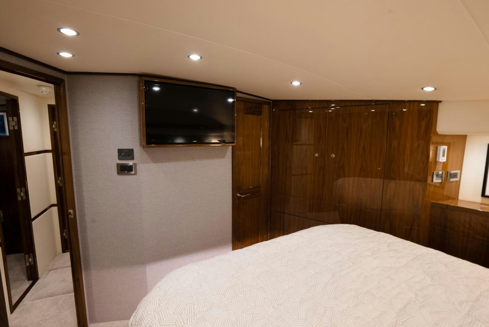 a hotel room with a tv on the wall aboard DAWG DAZE Yacht for Sale