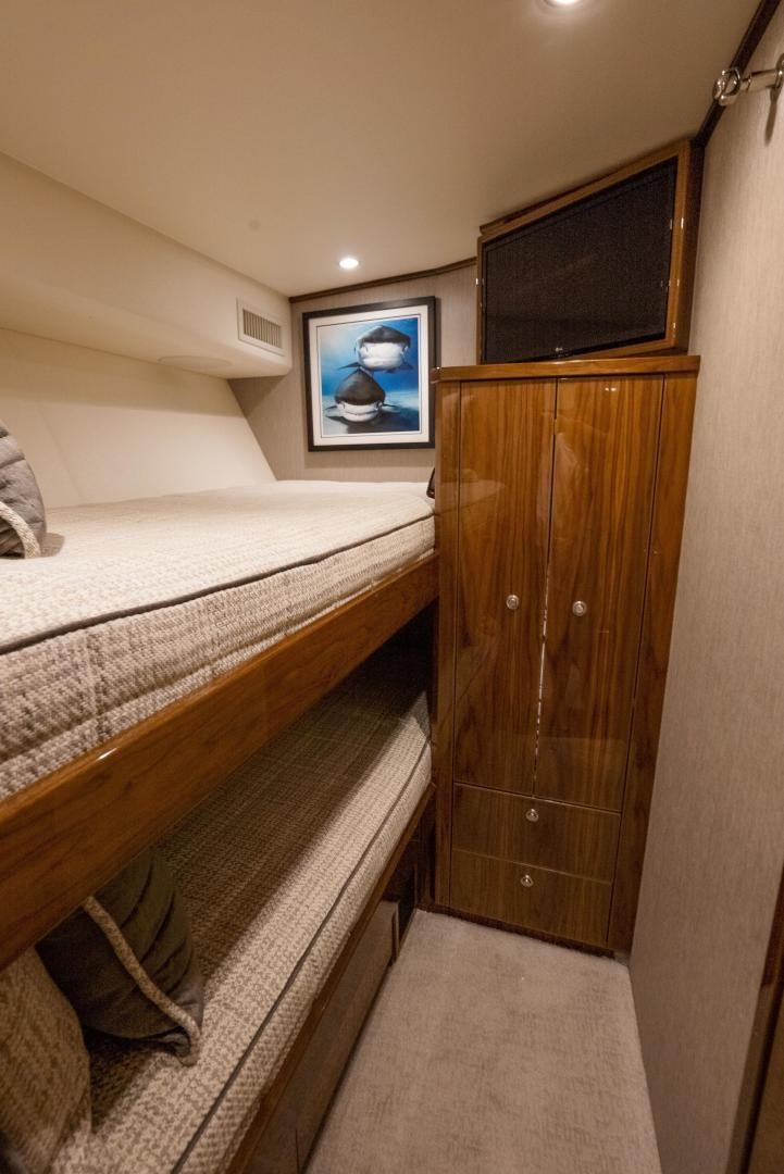 a bedroom with a bed and a television aboard DAWG DAZE Yacht for Sale