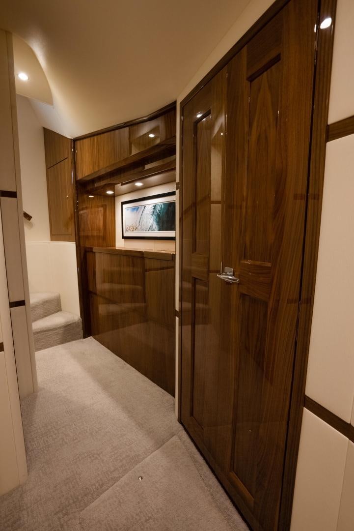 a room with a wood door and a tv on the wall aboard DAWG DAZE Yacht for Sale
